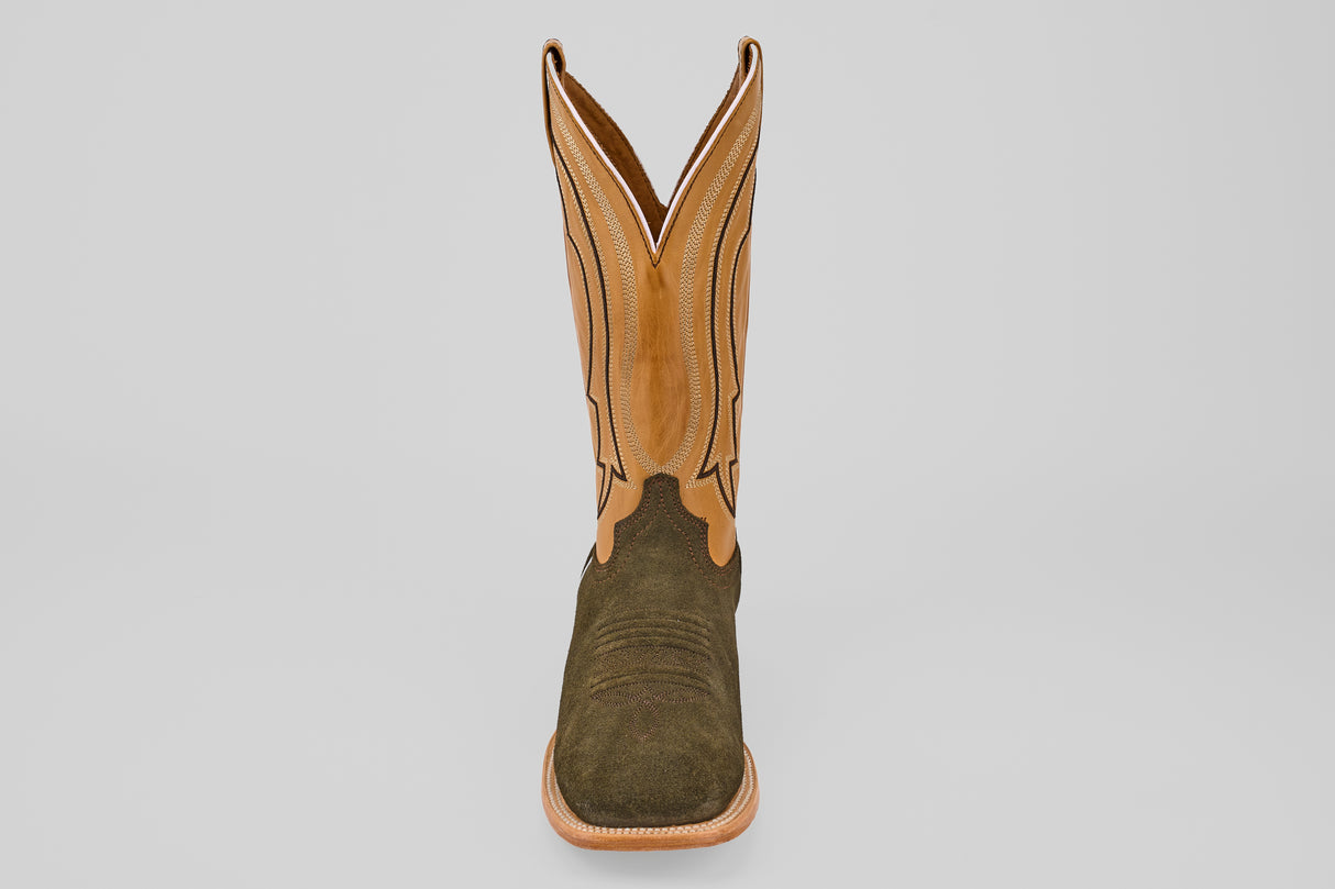 The Prime Suede Green Olive - Square Toe men’s boot features a green olive suede foot, tan leather shaft with decorative stitching, and a square toe, displayed facing forward on a plain light background.