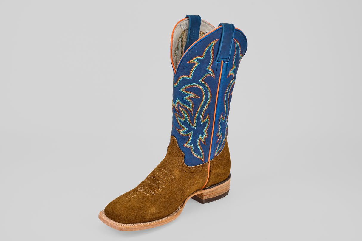 The Gold Suede - Square Toe boot features a brown suede foot, tall blue leather shaft, and colorful stitching, all displayed against a plain light gray background.