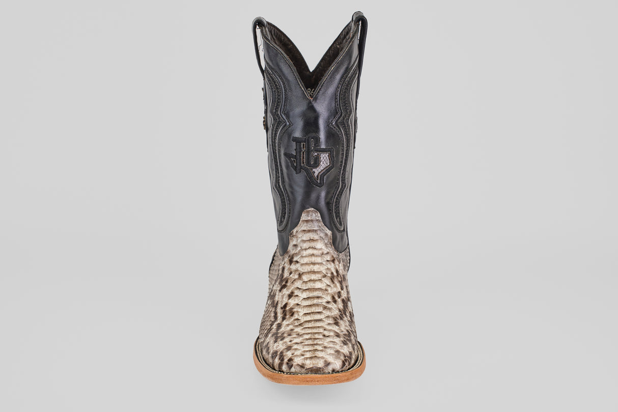 The Tanner - Natural - Square Toe cowboy boot features a textured Python Natural lower and a black leather upper with a stitched Texas outline and star, shown from the front against a plain background.