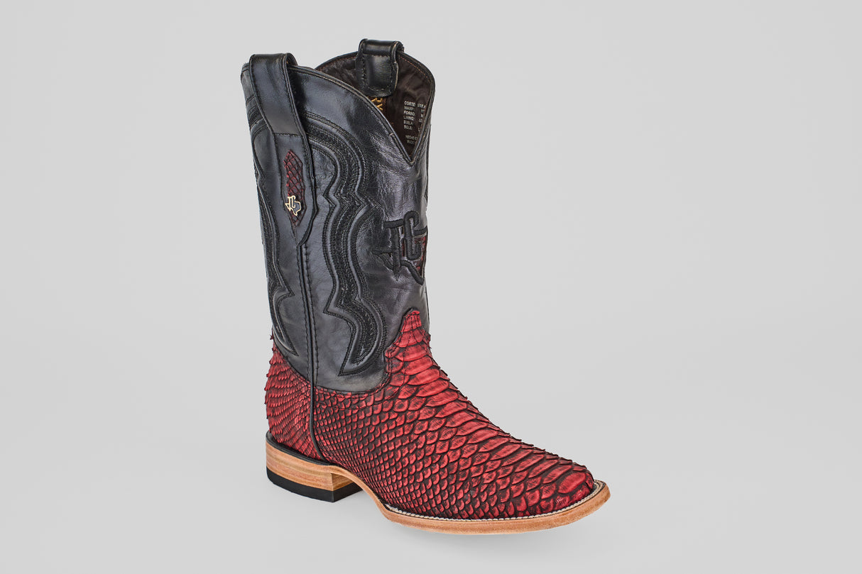 The Tanner – Scarlet – Square Toe is a western-style cowboy boot with a black leather upper, red textured python leather lower, square toe, wooden sole, and decorative stitching.