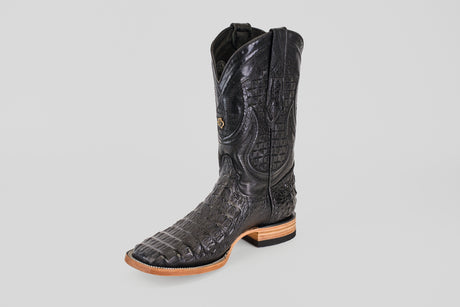 The Exotic Caiman Horn Back - Black - Square Toe boot features a textured, alligator-like pattern, a square toe, and a light brown sole, displayed against a plain light background.