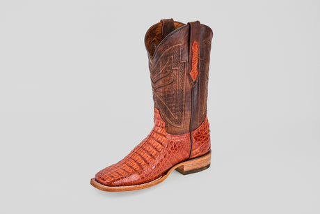 A single Exotic Caiman Horn Back - Brandy - Square Toe boot, featuring brown and reddish caiman leather with a textured hornback lower and a darker, intricately stitched upper shaft, set against a plain light background.