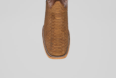 Top view of the Tanner - Tamarindo - Square Toe cowboy boot in brown Python Tamarindo leather featuring a textured snakeskin pattern and decorative stitching around the sole, displayed on a plain white background.