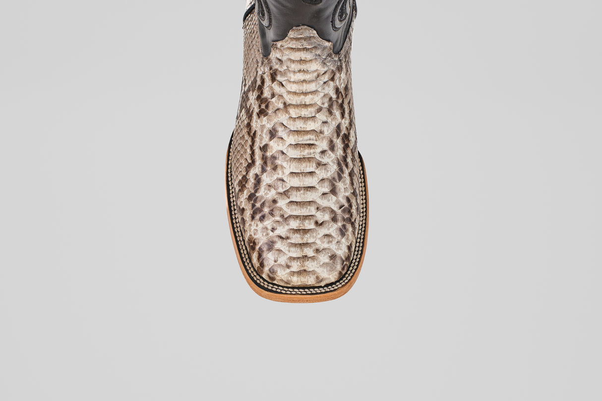 A top-down view of the Tanner - Natural - Square Toe cowboy boot with beige and brown Python Natural snakeskin, featuring a square toe and detailed stitching along the edge of the sole.