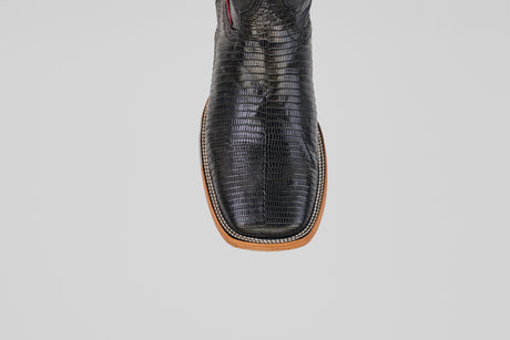 A close-up, top view of the Blaze – Black – Square Toe boots highlights their textured genuine black lizard leather with brown trim, set against a plain light gray background.