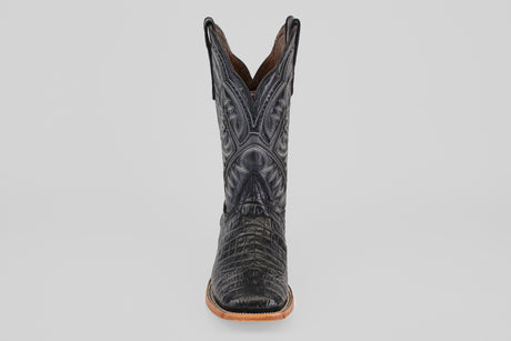 A single Caiman Belly Black - Embossed Leather - Square Toe (E423) boot featuring crocodile-like textured patterns and decorative stitching, shown front-facing against a plain light gray background.