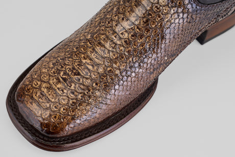 Close-up of the toe of the Tanner Platinum - Dune - Square Toe (Imperial) brown leather dress shoe, showcasing a python-inspired reptile pattern and square toe design against a plain light background.