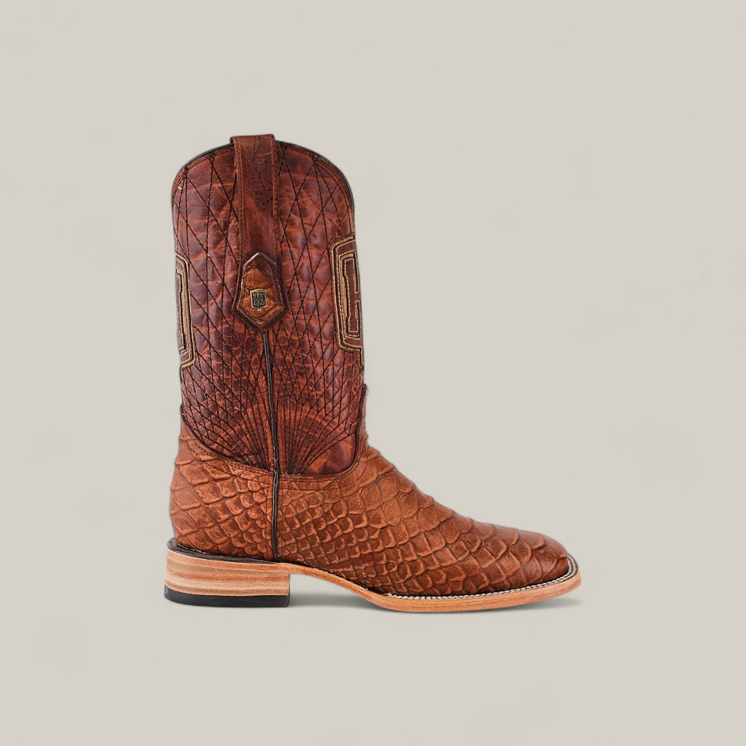 A single Python Print Rustic Cogñac - Square Toe boot, featuring textured leather with a scaled pattern, detailed stitching, and a squared toe, is displayed on a plain light background.
