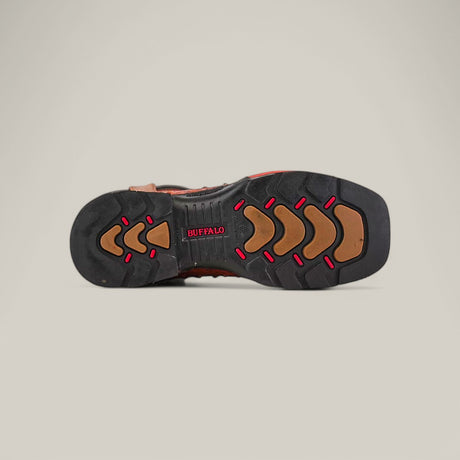 The image highlights the sole of an Ostrich Print Cogñac Soft Toe - E6022 shoe, featuring a rugged black tread with red accents and geometric patterns for durability. BUFFALO appears in red near the arch, reminiscent of Texas Country Work Boots against a light beige backdrop.