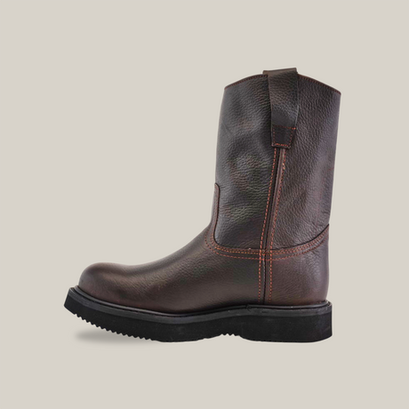 Against a plain white background, the Brown Roper - Laredo Sole - Soft Toe boot is shown in a side profile. This dark brown leather boot highlights exceptional craftsmanship with orange stitching, a pull tab at the top, and the classic black Laredo Sole.